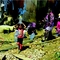 Children haul water at the makeshift refugee camp for Syrian farmworkers in Zadnael, Lebanon.