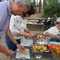 Eduardo Conde (Methodist pastor), Nini Titosse (Presbyterian pastor), and Manuela cutting tomatoes for salad