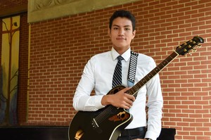 Caleb Chincoya with his guitar after undergraduate chapel at the University of Dubuque.