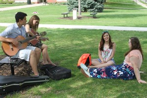 Caleb Chincoya sings with fellow students on the University of Dubuque quad.