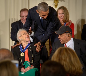 President Barack Obama presents former NASA mathematician Katherine Johnson with the Presidential Medal of Freedom, as professional baseball player Willie Mays, right, looks on, Tuesday, Nov. 24, 2015.