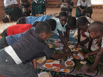 Children in Malawi use food cards to learn about healthy foods.