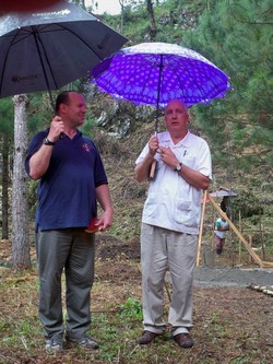 Two men under umbrellas