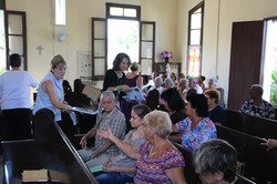 handing out Bible studies in Cuban church
