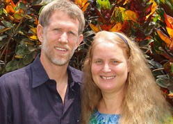 Photo of Jeff and Christi Boyd in front of an African textile.