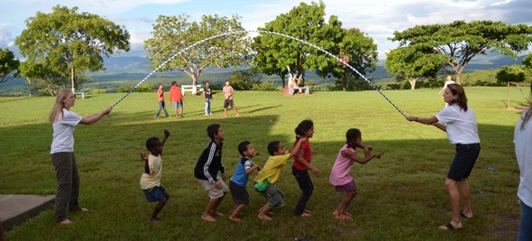 Children at Montaña de Luz enjoy a warm day and play jump rope on the grassy mountain in south central Honduras that is home to the orphanage.