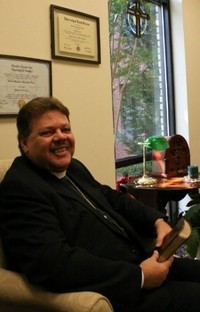 Pastor seated in study