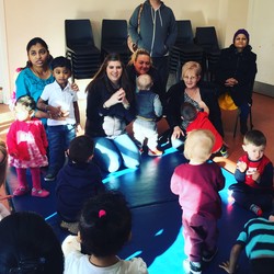 teacher with children gathered around