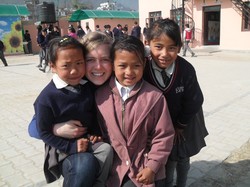 Anna Curl and school children in South Korea